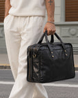 Black leather briefcase for men with dual handles, double zip compartments and detachable shoulder strap