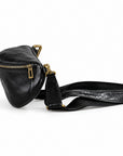 A black leather crossbody bag with a textured patterned strap and gold-tone hardware.