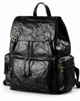 A black crinkled leather backpack with gold-tone hardware, shown on a clean white background.