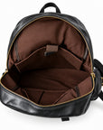Open black leather backpack showing a brown fabric interior with gold-tone zippers and internal pockets.