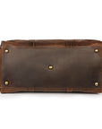 Bottom view of a brown Crazy Horse leather weekender bag with metal feet for enhanced durability during travel.