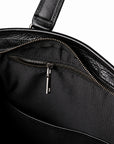 Classic black full-grain leather tote inner zipper pocket with black fabric lining and a metal pull