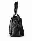 Classic black full-grain leather tote side view with a detachable strap and metal adjuster