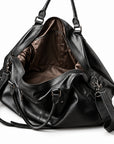 Elegant black full-grain leather duffel bag with an open main compartment and brown lining.