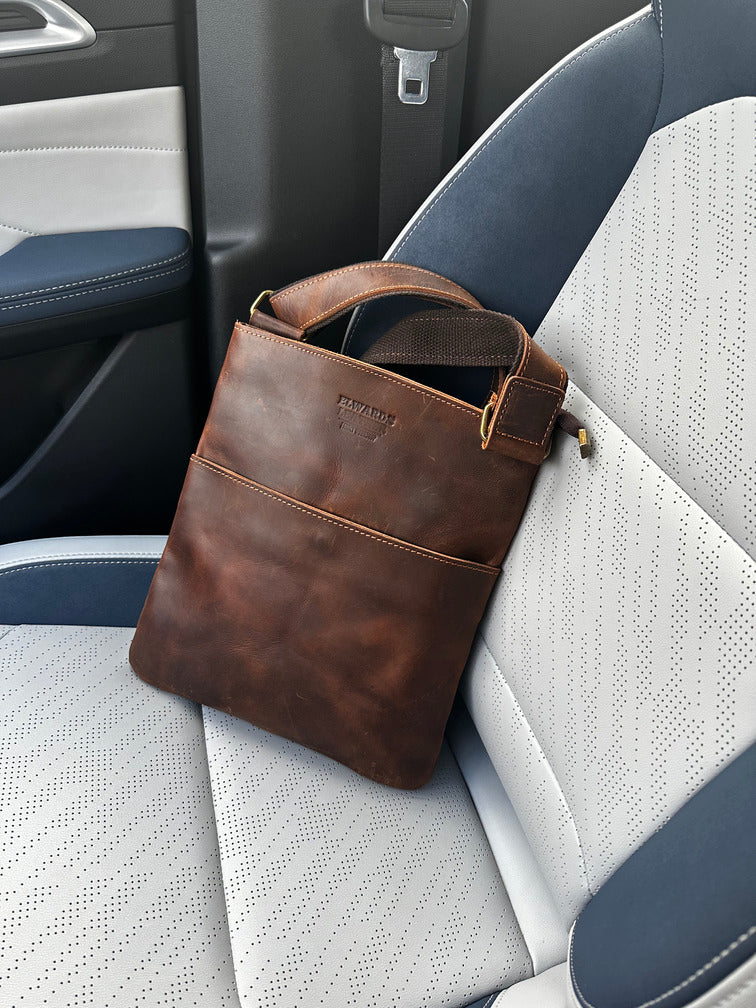 Elegant men's crossbody leather bag in brown with a minimalist design for everyday carry.