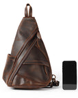 Brown leather sling bag with a smartphone on a white background