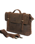 Close-up of a handmade vintage leather briefcase and men's messenger bag with detachable strap and brass hardware.