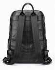 Black leather backpack shown from the back, featuring a quilted chevron pattern on the back panel, a top handle, and wide padded shoulder straps, photographed on a white background.