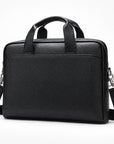 A black textured leather briefcase-style bag with dual top handles and a detachable shoulder strap, shown on a clean white background.