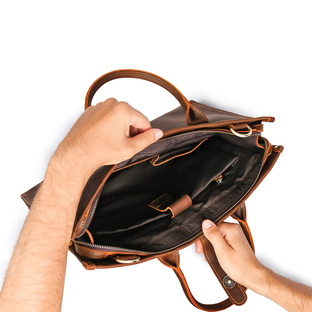 Men's brown Crazy Horse leather shoulder bag with a laptop and accessories, perfect for a professional look