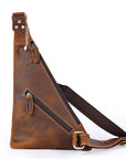 Brown leather sling bag with a strap on a white background