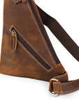 Brown leather sling bag with a strap on a white background