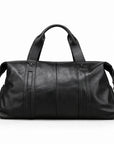 Modern black full-grain leather duffel bag rear view with stitched leather handle bands.