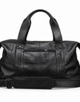 Modern black full-grain leather duffel bag with front zip pocket and wide leather handles.