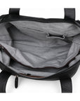 Modern black full-grain leather duffel bag interior with gray lining, slip pockets and a zip pocket.