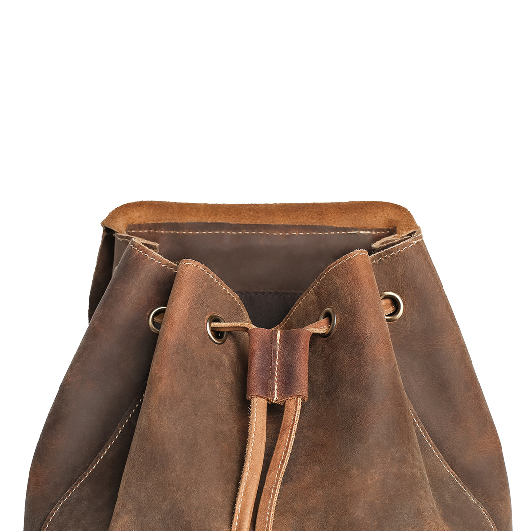 Open-top view of a vintage brown crazy horse leather backpack showcasing its drawstring closure and spacious interior