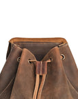 Open-top view of a vintage brown crazy horse leather backpack showcasing its drawstring closure and spacious interior