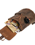 Vintage brown leather backpack filled with books and a thermos, highlighting its capacity and functionality for daily use