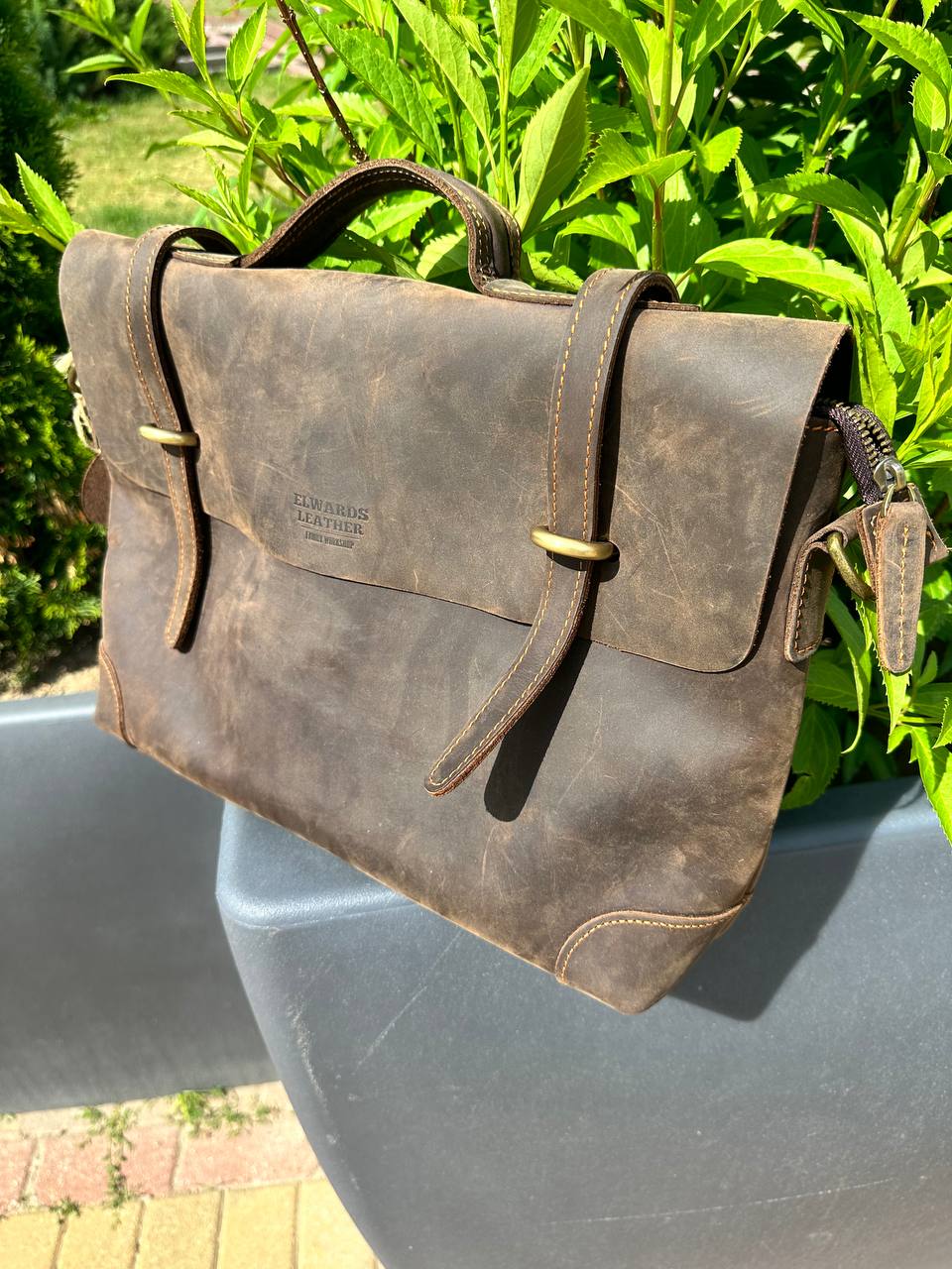 Premium brown leather laptop bag for men with elegant stitching and practical compartments.