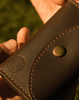 Unboxing a handmade Crazy Horse leather key case outdoors, showcasing its premium craftsmanship and vintage design.