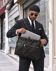 Professional black leather laptop bag for men with shoulder strap, top handles and spacious compartment for laptop and office essentials