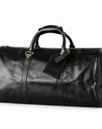 Refined black full-grain leather duffel bag at an angle showing its rounded end and leather trim