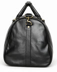 Refined black full-grain leather duffel bag side with leather piping and a detachable strap clasp
