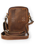 Brown leather crossbody bag with a strap on a white background