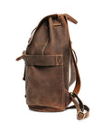 Close-up of a brown Crazy Horse leather backpack side pocket highlighting stitching details and easy-access design.
