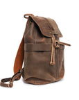 Close-up of a brown Crazy Horse leather backpack showcasing pocket and stitching details