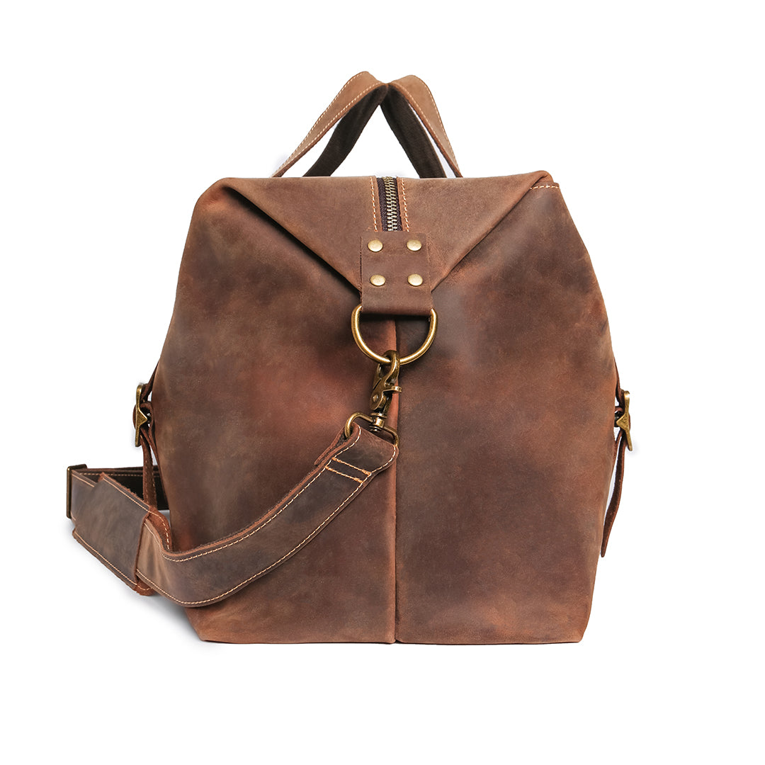 Side profile of vintage travel duffle bag, showcasing its elegant design and reinforced stitching for durability.