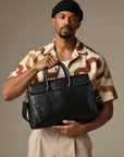 Slim black leather business briefcase for men with top handles, removable shoulder strap and professional work bag design