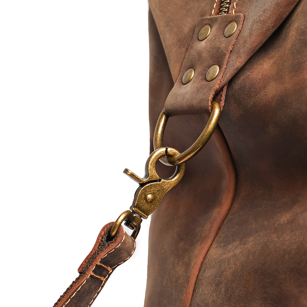 Stitching and hardware details on a vintage leather bag, emphasizing artisanal craftsmanship and quality.
