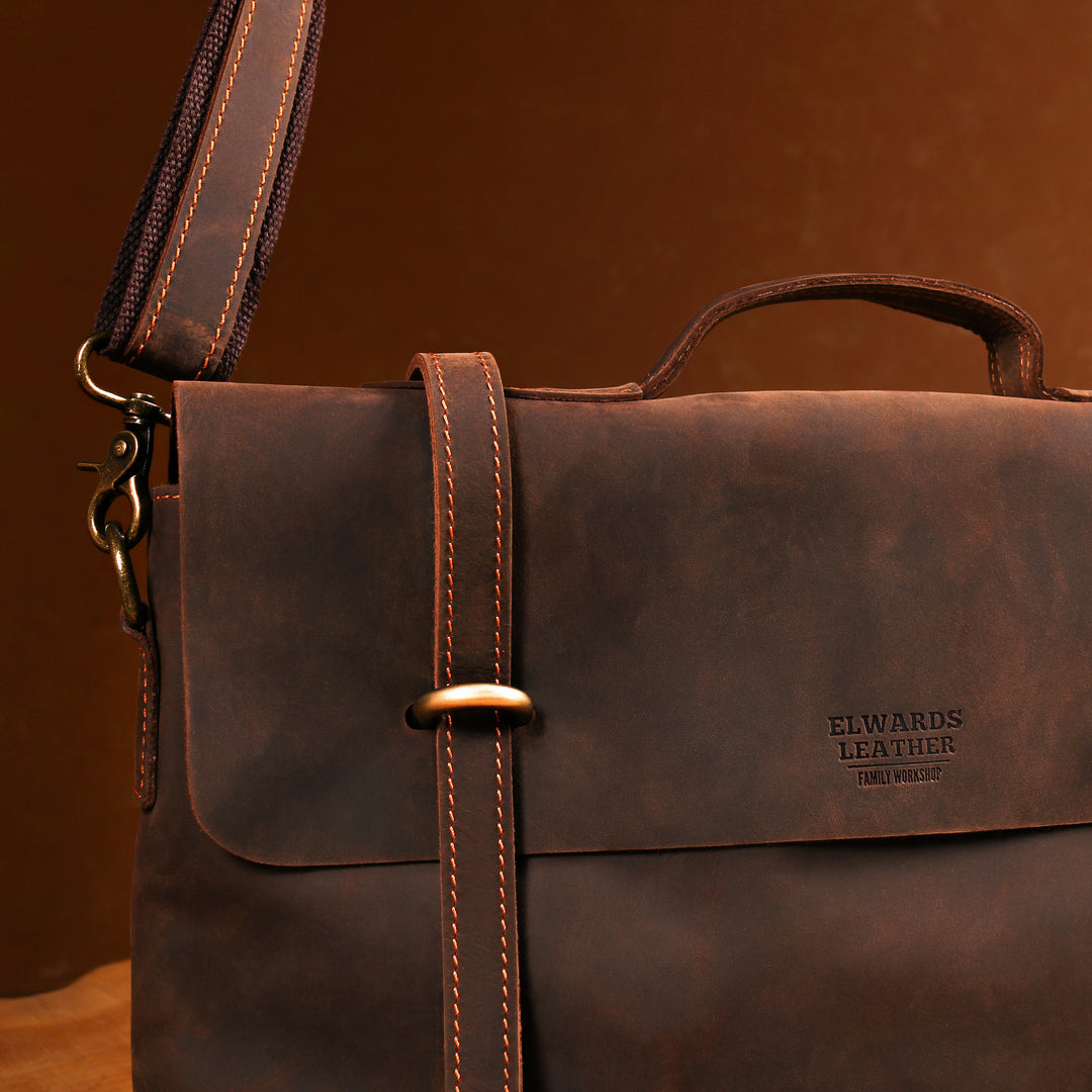Stylish men's brown leather briefcase with reinforced handle and vintage details.