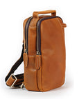 Tan leather sling bag side view with double zipper design and shoulder strap