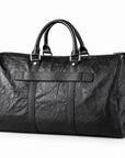 Textured black full-grain leather weekender bag at an angle showing the rounded side panel