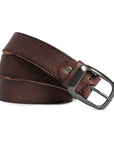 Close-up view of a vintage-style brown leather belt rolled up, highlighting its sturdy metal buckle and hand-stitched edges.