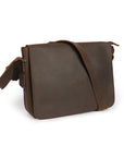 Angled view of a dark brown handcrafted leather satchel with adjustable strap, ideal for work and travel