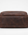 A dark brown distressed leather rectangular pouch or small bag, shown from the front against a clean white background.
