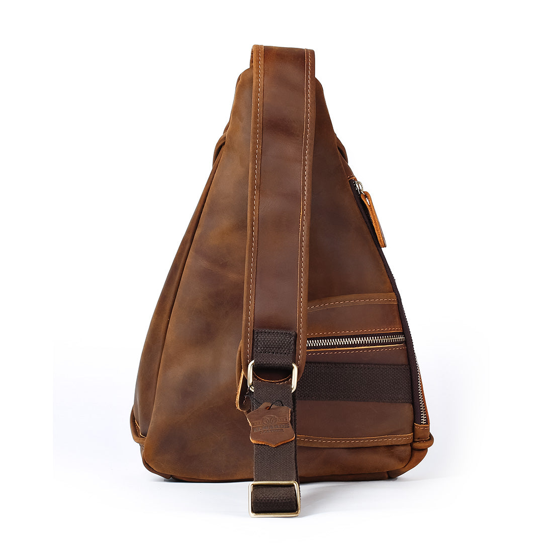 Brown leather sling bag on a white background