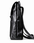 A black full-grain leather backpack shown from the side profile against a clean white background.