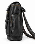 Black full-grain leather backpack with a tall side zip pocket and adjustable straps, side view