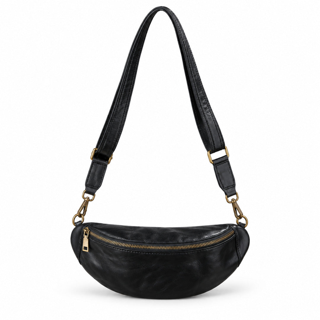 Black leather fanny pack with a gold zipper and gold-tone hardware, featuring an adjustable black shoulder strap.