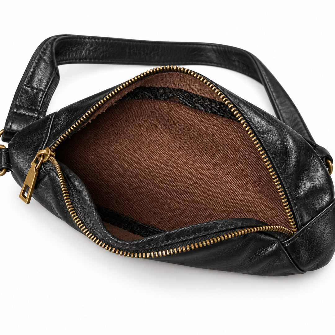 Black leather crossbody bag shown open, displaying a brown fabric interior and gold-tone zippers with a matching leather strap.