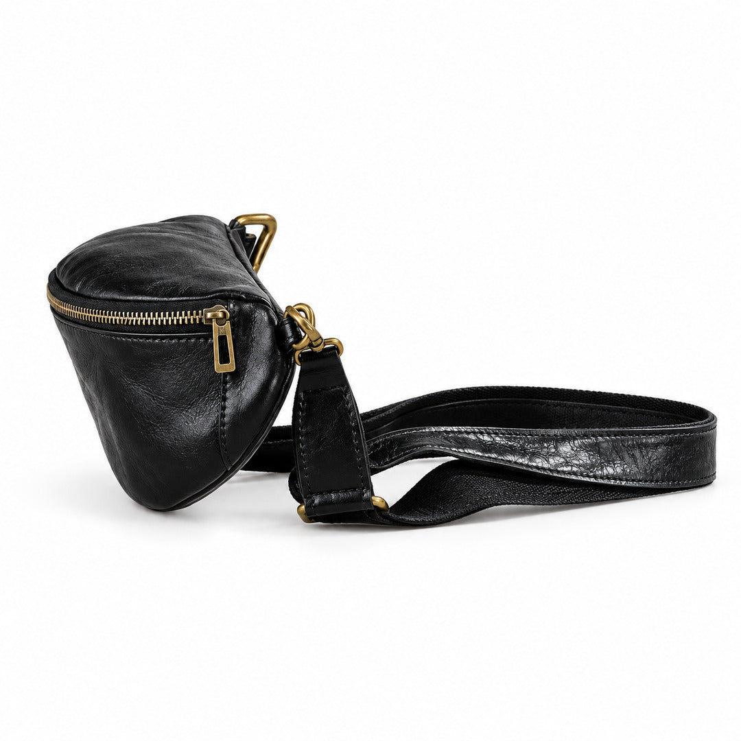 A black leather crossbody bag with a textured patterned strap and gold-tone hardware.