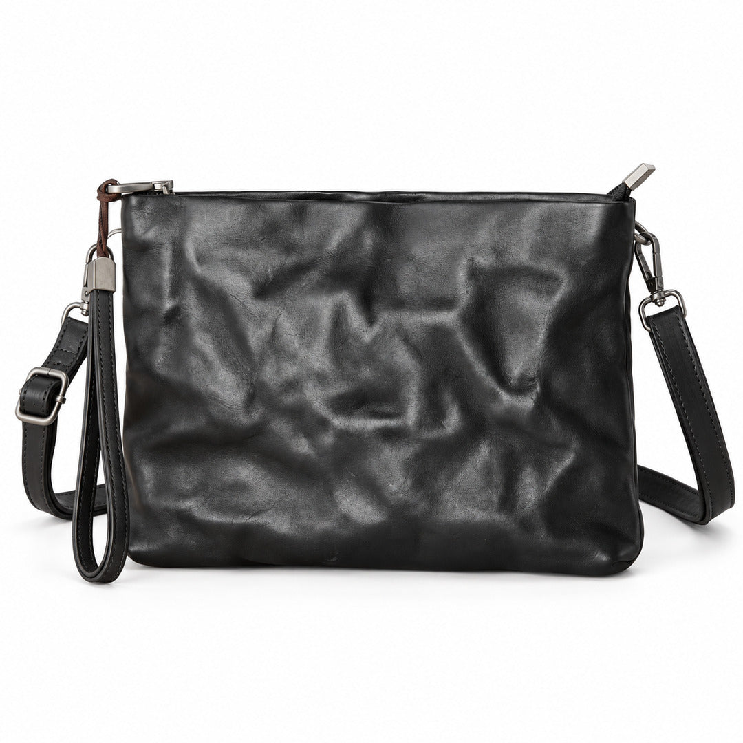 Black leather clutch bag with a crinkled texture, featuring a wristlet strap, top zipper closure, and a detachable shoulder strap.