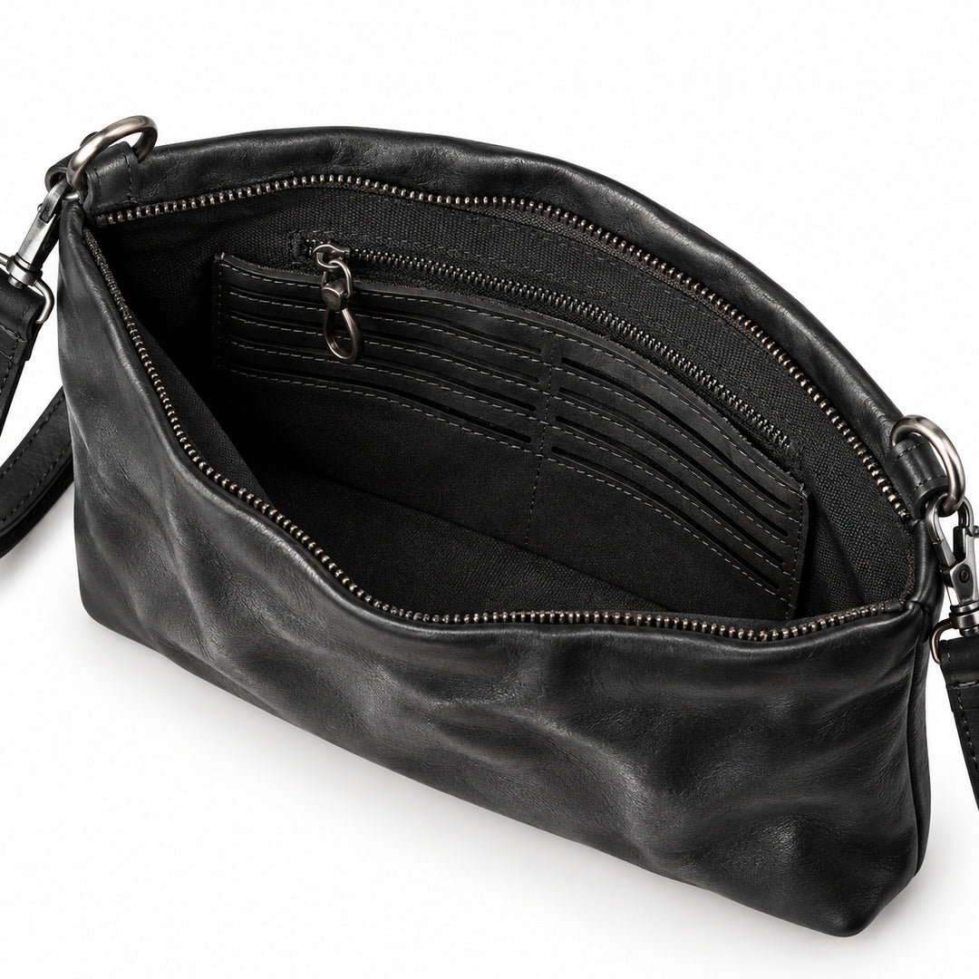 Black leather clutch bag shown open to display its interior, featuring multiple card slots, a zippered pocket, and a black shoulder strap with silver-tone hardware.