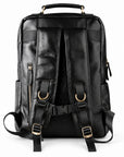 Black leather backpack shown from the back, featuring padded shoulder straps, a top carry handle, side zip pockets, and gold-tone hardware.