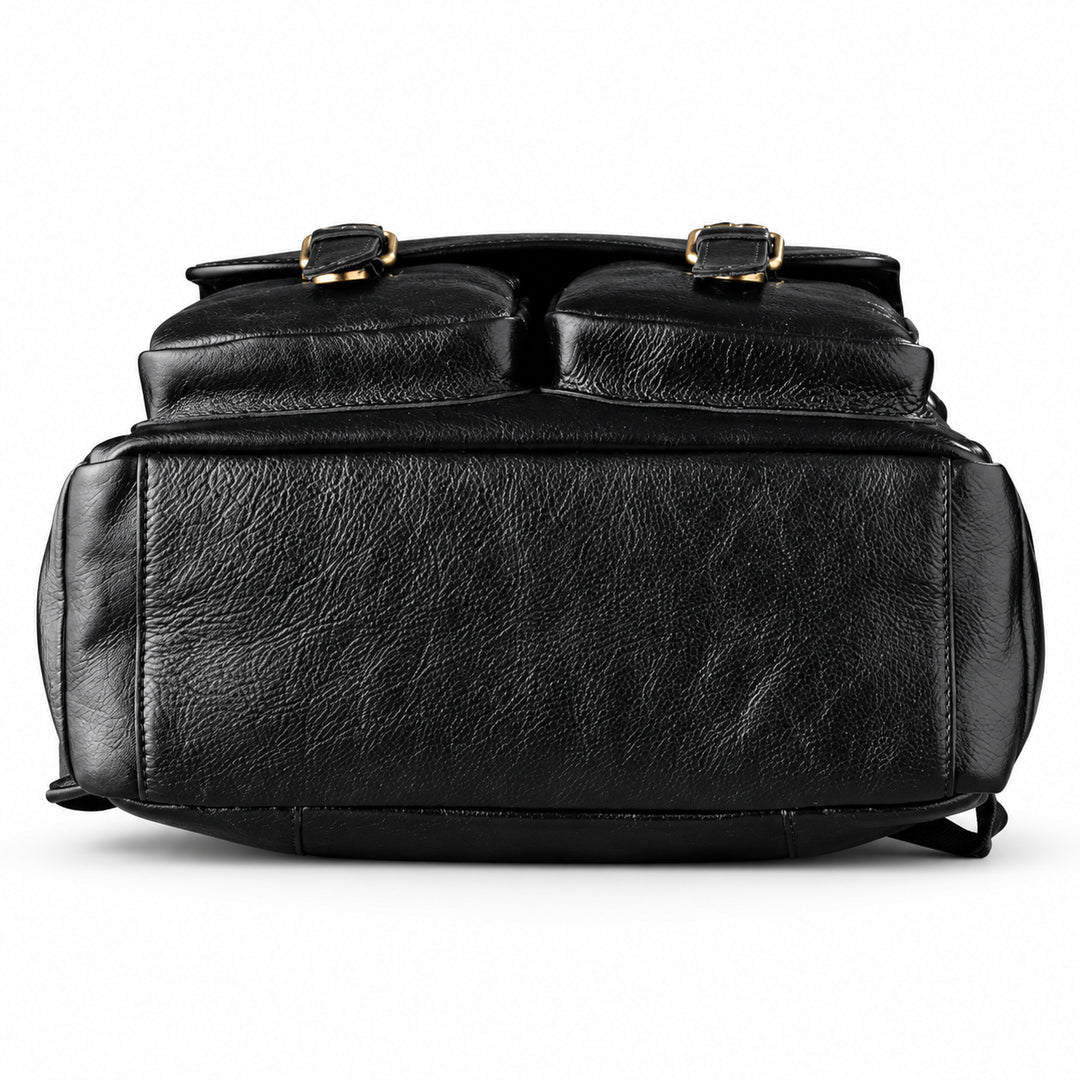 Black textured leather backpack shown from the front, featuring two top flap pockets with gold-tone buckle details.