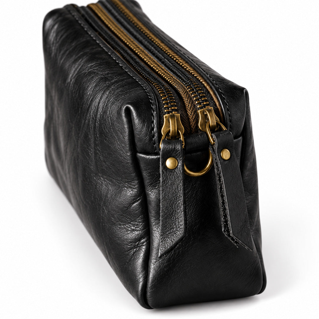 Black leather pouch with gold-tone zippers and hardware.